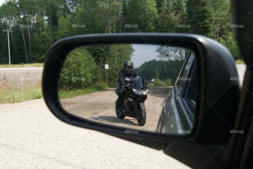 Moto mirror . Reflection of motorcycle in car mirror