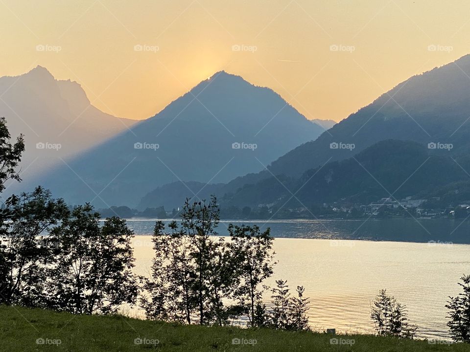 The sky broke like an egg into full sunset and the water caught fire.