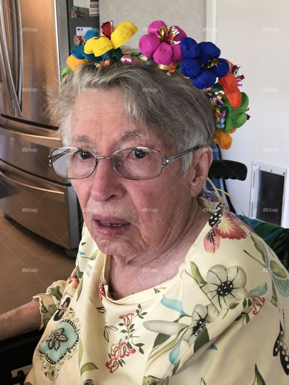 Elderly woman with flowers in hair