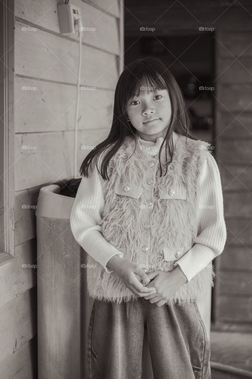 Inspired by old vintage photography, portrait of a young little girl in monochrome.