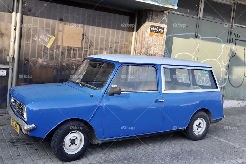 Blue retro car parking in the street