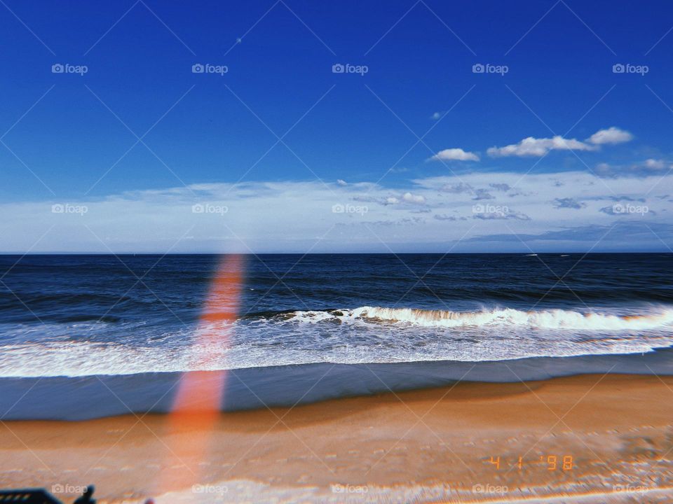 Light Bleed On Sandy Beach With Waves
