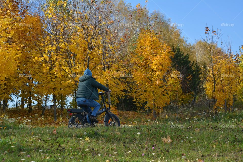 men riding on a bike autumn beautiful landscape