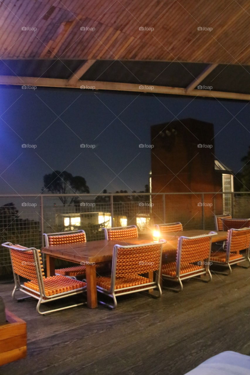 Empty dining table on the terrace at night