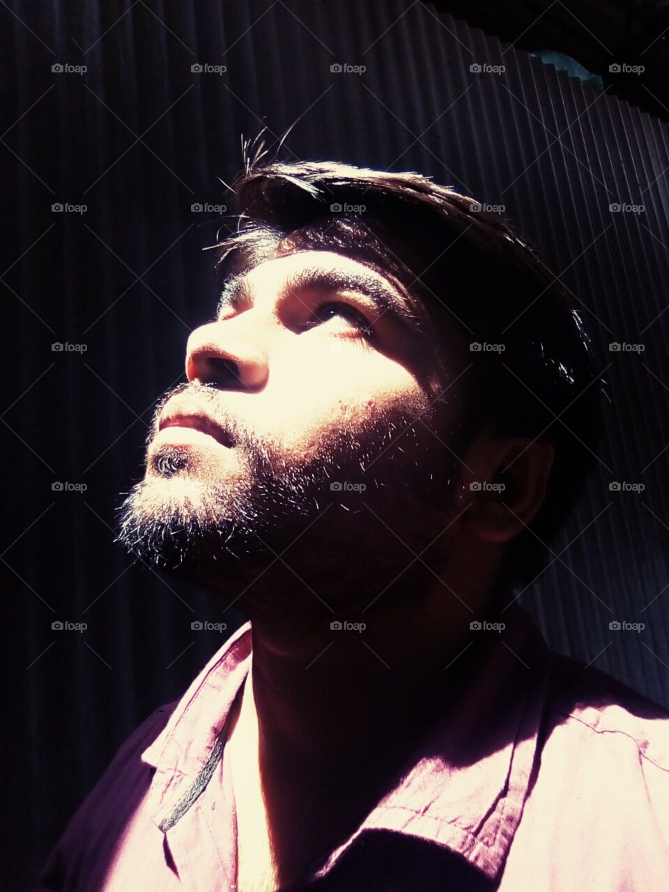 Fighting with Darkness !
Man with hope see towards sky dare to face the problems dare to fight sadness.
His beard show his patient !
His head up show his attitude to never give up !
His expression say I never giveup !
His eye towards target egear !