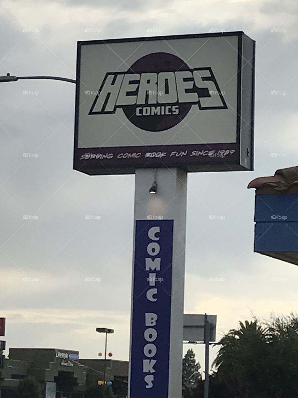 Comic book store sign. The ample, vivid sign would definitely prevent motorists from missing it. Not only that, they would know the location of the shop itself as well, thanks to the large advertising sign.