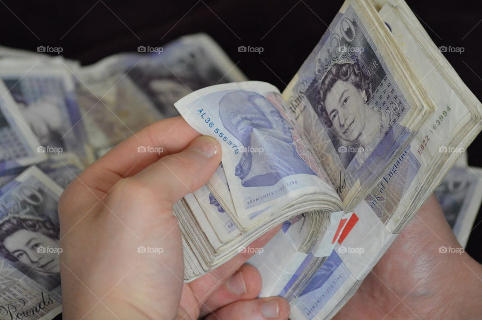 Close-up of hands holding currency