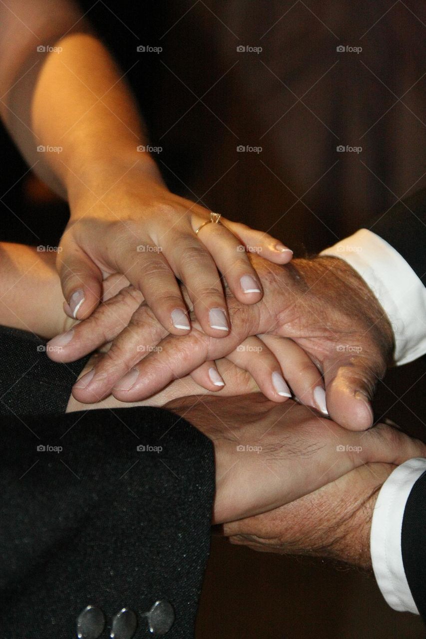 Hands in a pray during a wedding ceremony