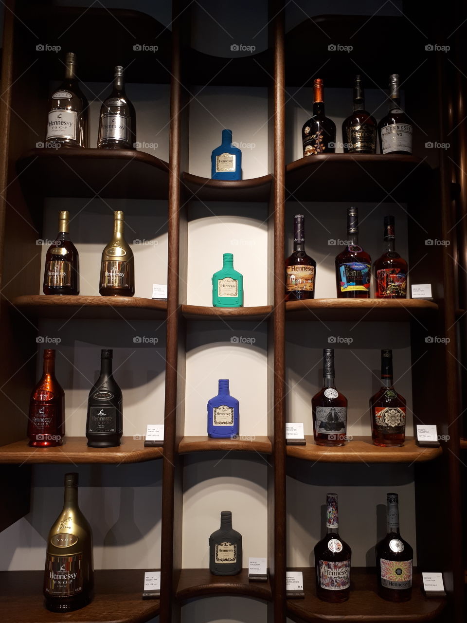 Shelfs with Hennessy cognac bottles