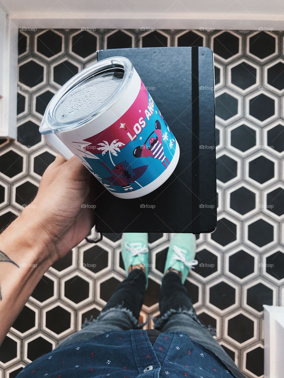 standing on a cool tile floor holding a coffee mug. 