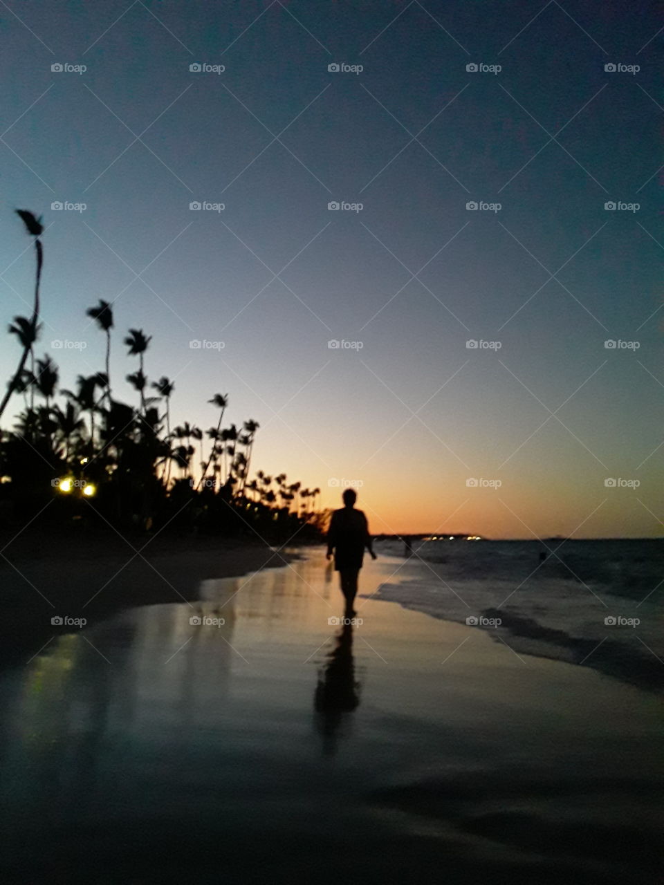 beautiful sunset woman walking on the evening beach