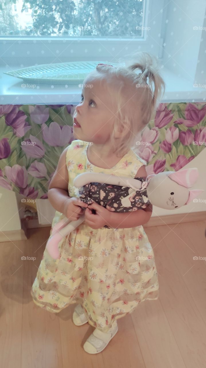 cute girl and a toy cat