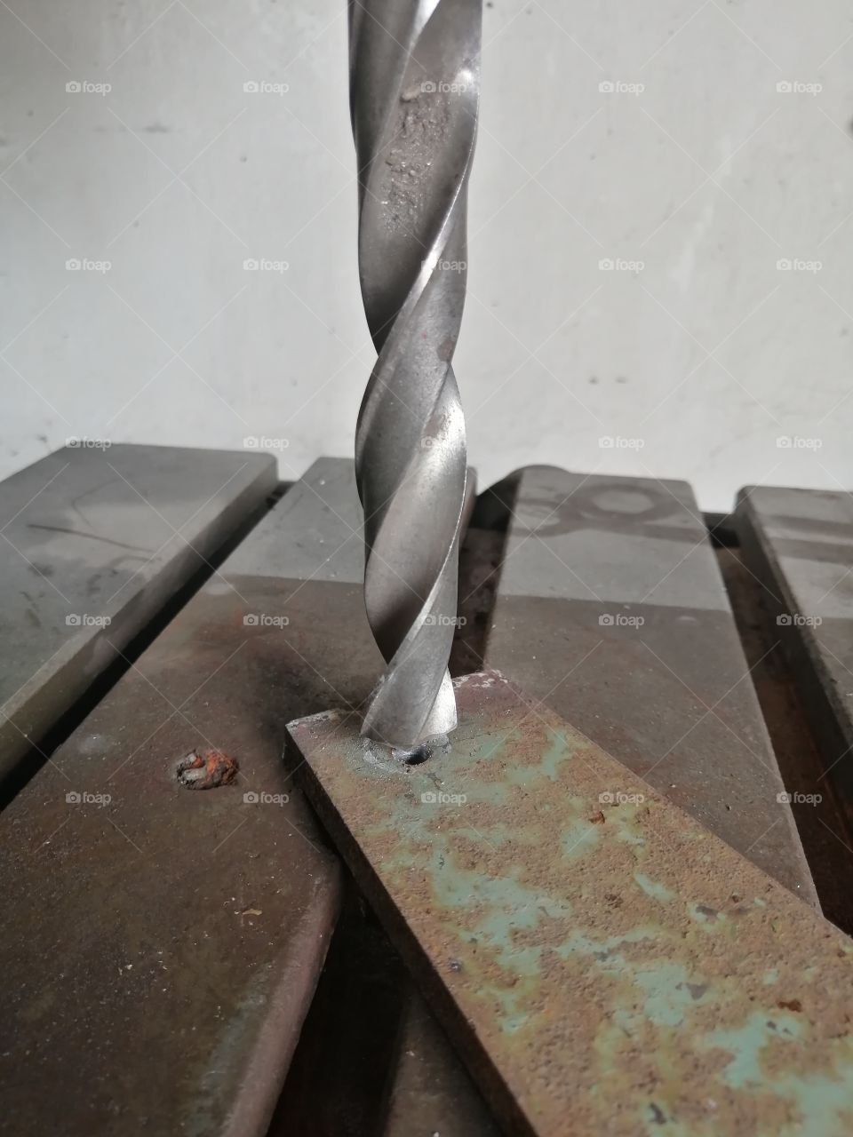 drill in work with metal plate close-up