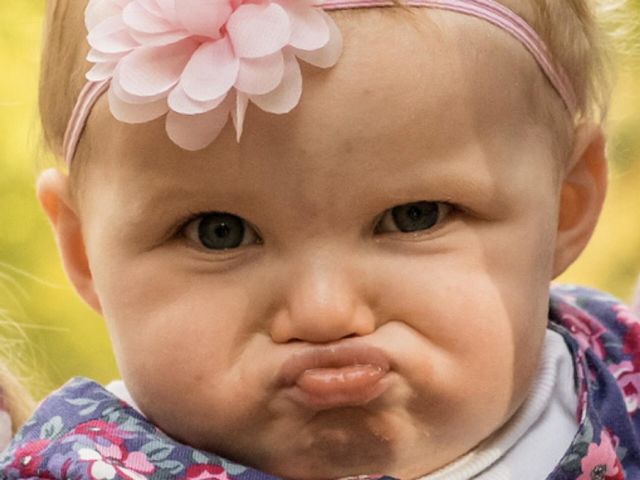 Young child pulling a rather funny disgusted facial expression 