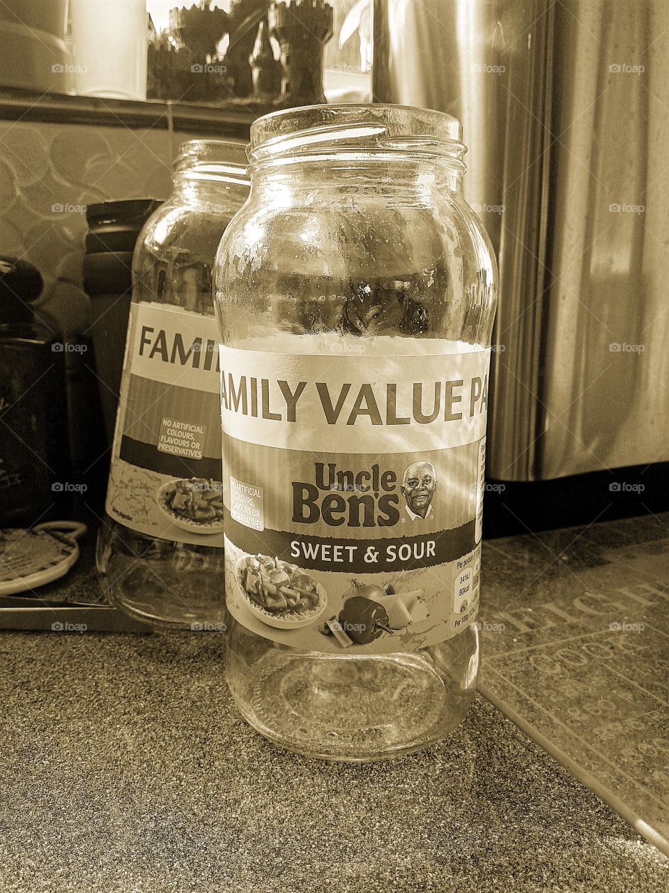 two jars of Uncle Ben's sweet and sour sauce in sepia tone