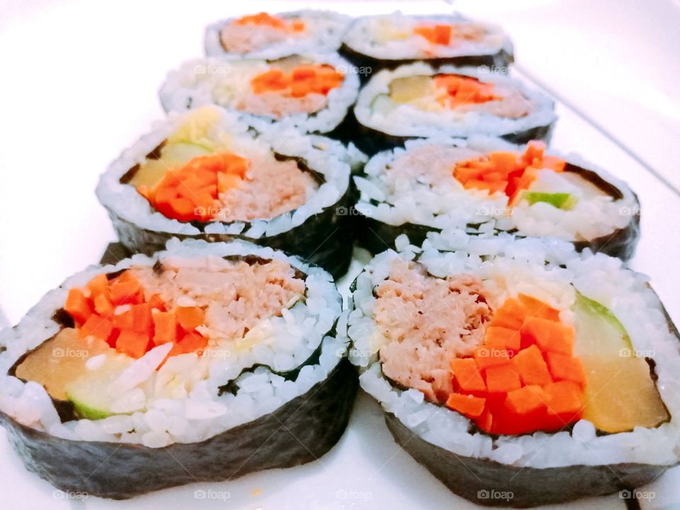Tuna Kimbap (Korean "sushi" rolls)

Kimbap/gimbap or simply known as Korean "sushi" rolls.
Steamed sticky rice with tuna, carrots, yellow pickled radish, cucumber, and cabbage wrapped in seaweed sheet.
Delicious and healthy!