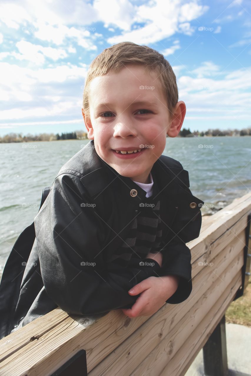 Boy hanging out at the lake one Autumn afternoon 