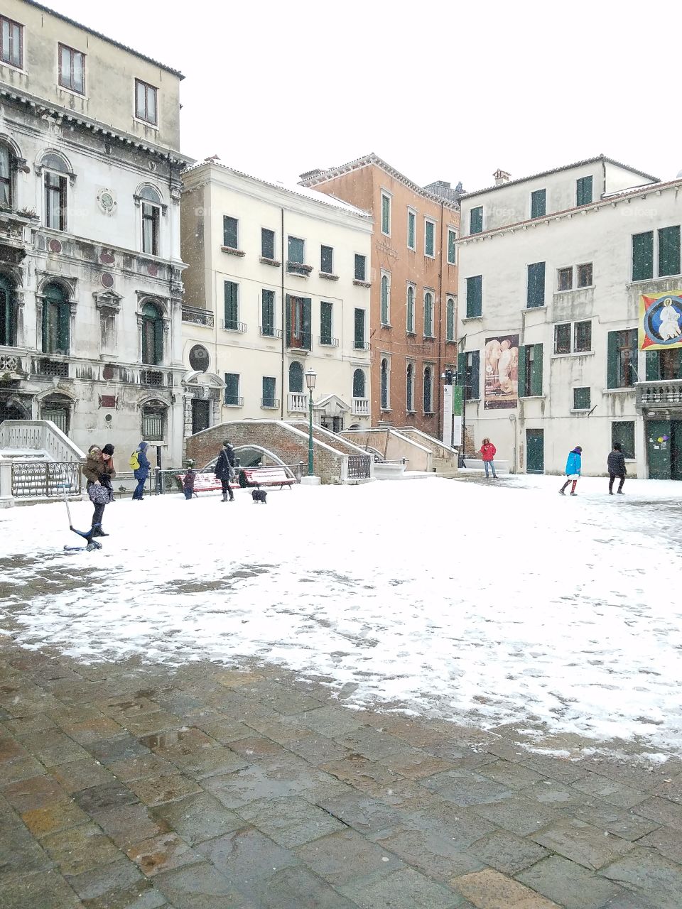 Families playing in snowy Venice