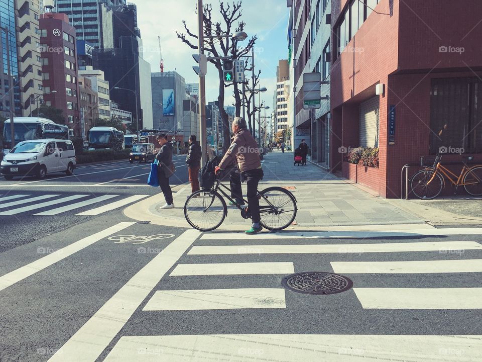 Man biking on the street, Japan