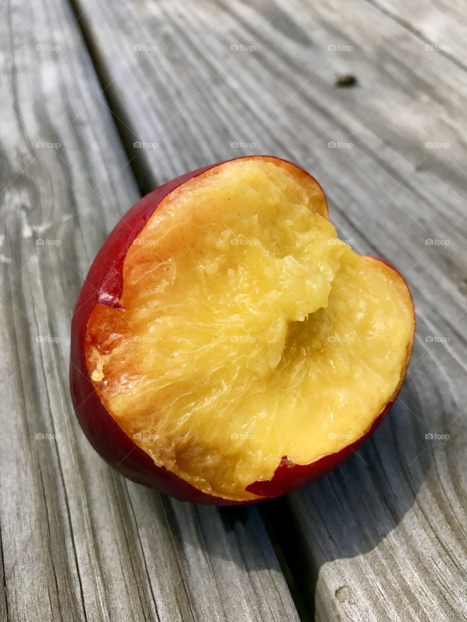 Perfect imperfections, bite out of nectarine 