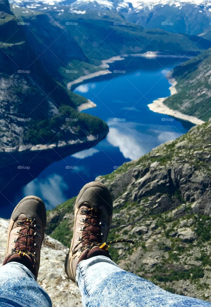 Feet view from Trolltunga rock above Geirengerfiord in Norway. 
