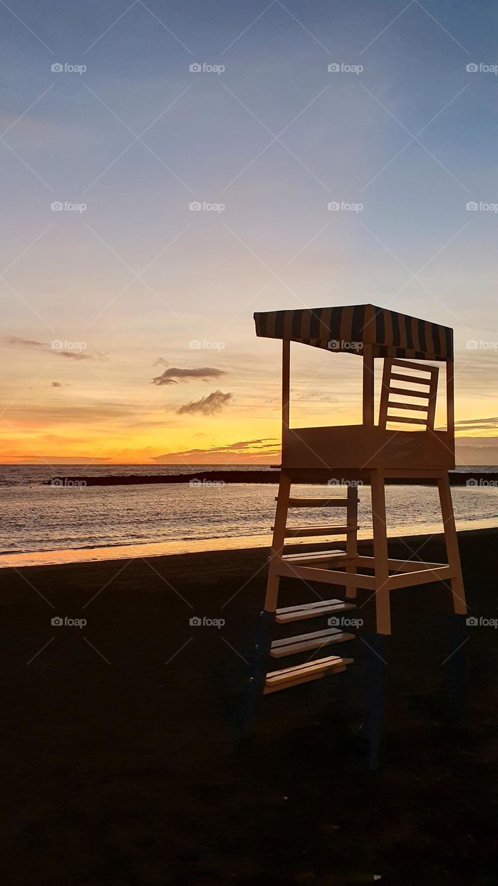 colors of Autumn - Life Guard Chair at the beach - sunset by the sea with breathtaking colors