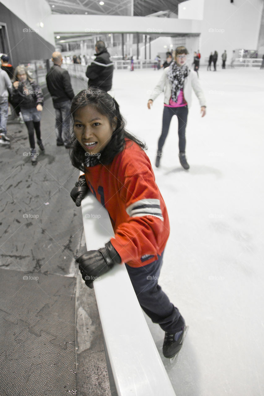 Thai lady trying ice skating for the first time .  Sriwan from Thailand trying ice skating for the first time