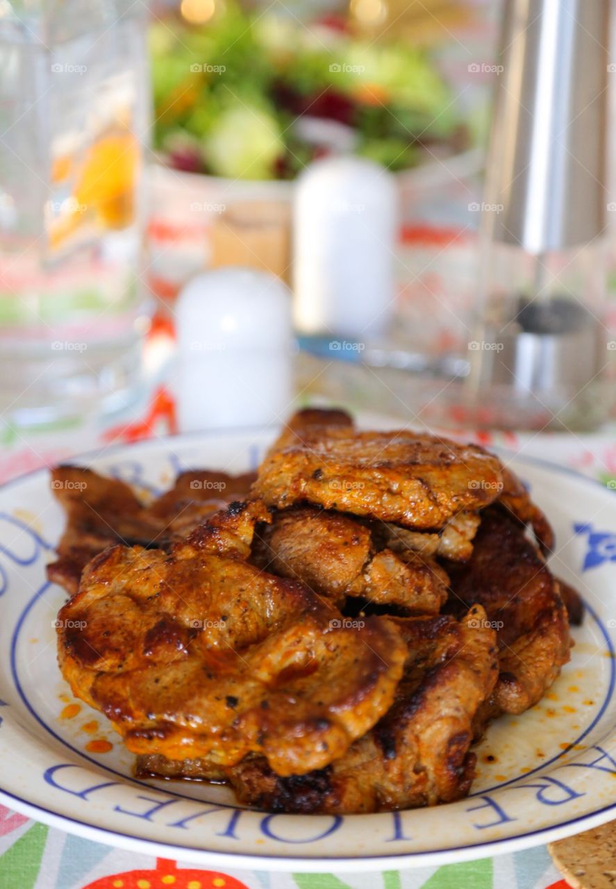 Bbq dinner. Bbq meat and salad on the table