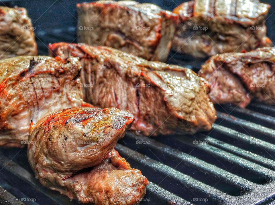 Steaks cooking on grill