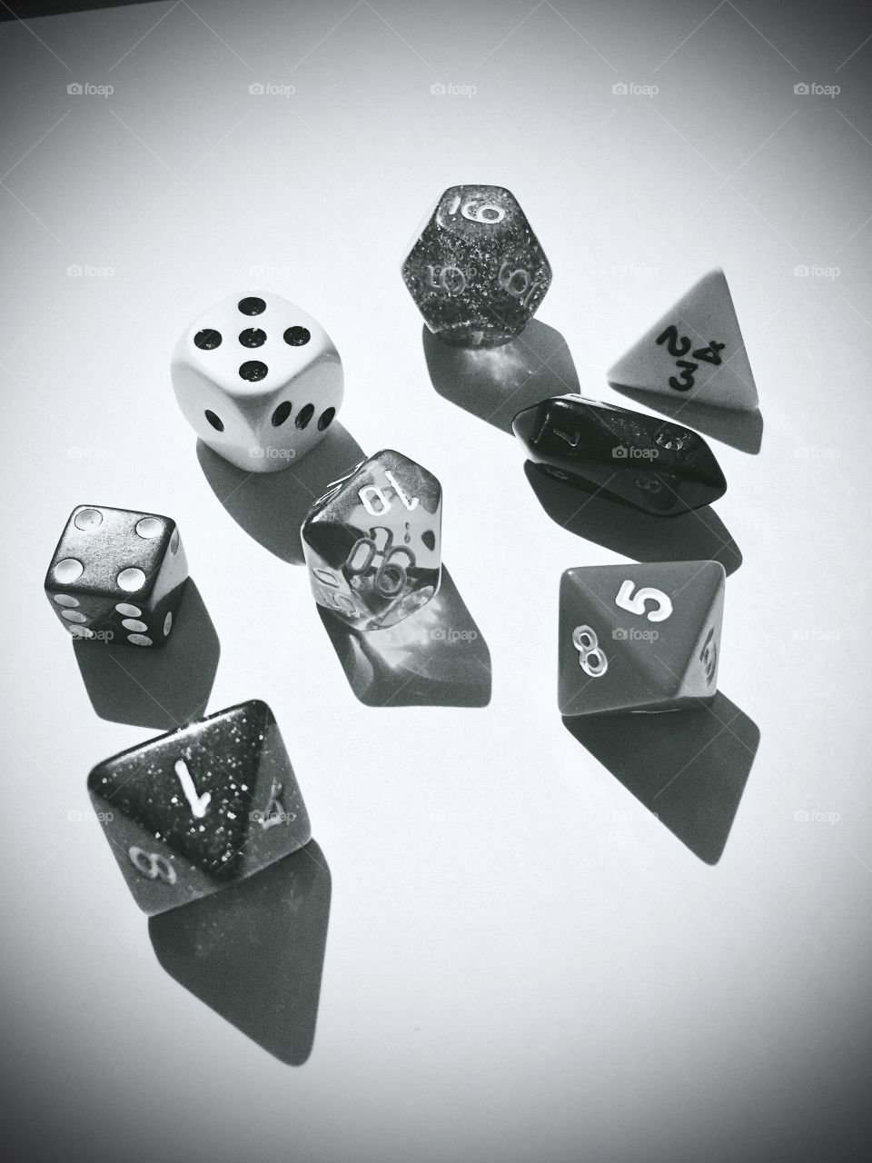 An assortment of dice in a beam of sunlight