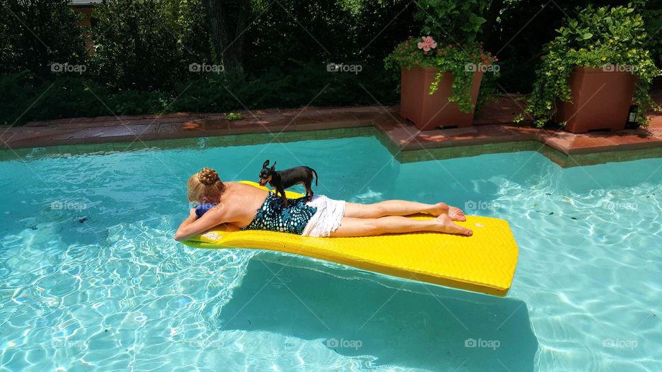 woman on raft with dog