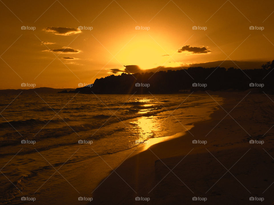 Surf at beach during sunset