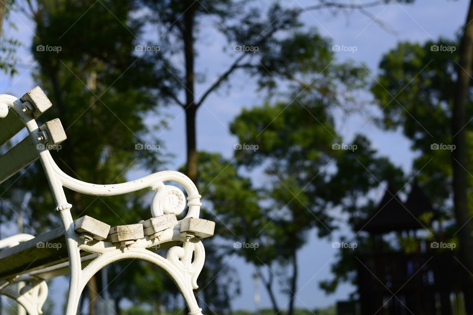 White iron bench in park