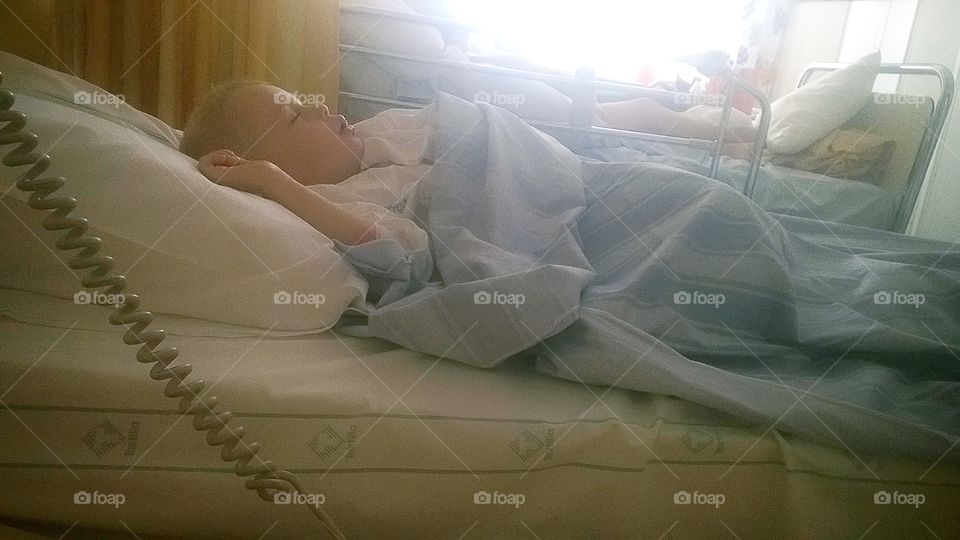 Child laying in the bed at the hospital