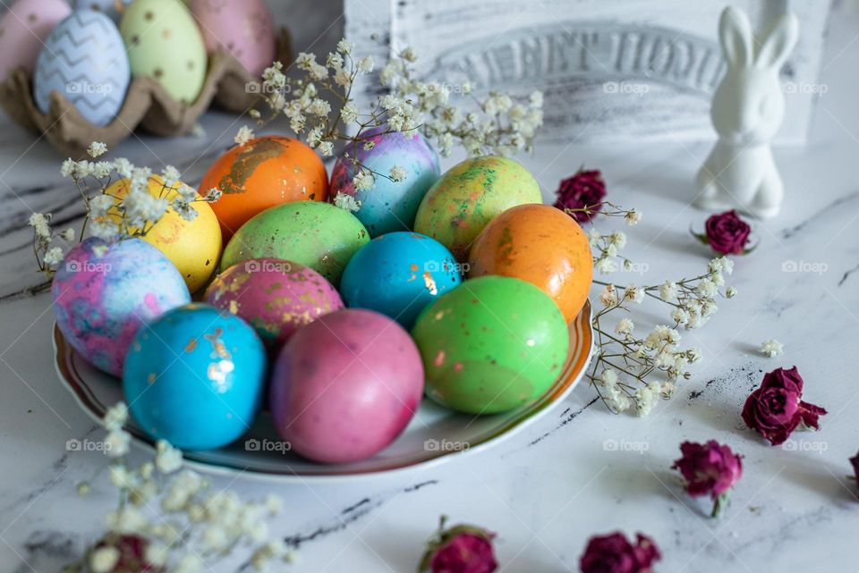 Craft product homemade painted colored Easter eggs on a light wooden background