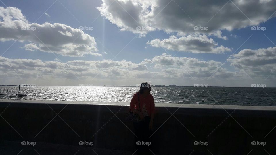 Woman standing by bay