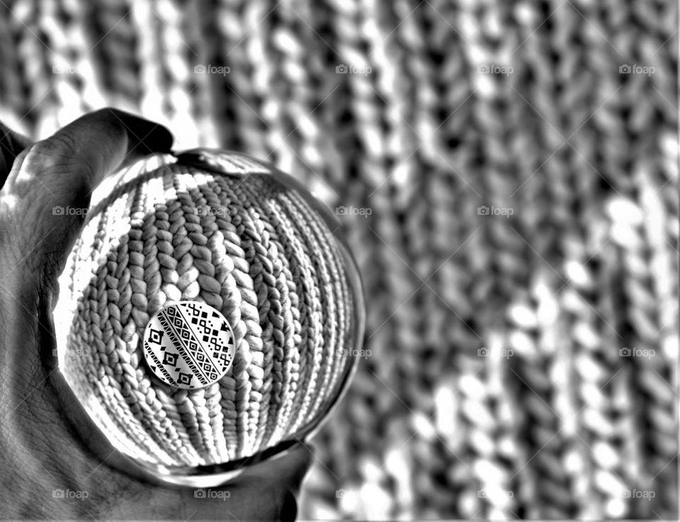 abstract black and white picture with circle shaped coaster seen trough a round crystal clear ball which creates a nice fish eye perspective