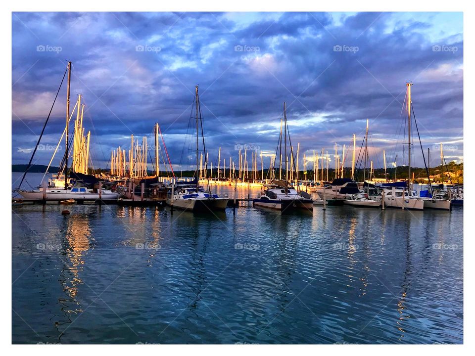 sunset sunlight coloring sailboats in a marina, Bahia, Brazil