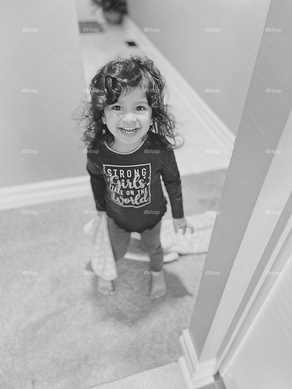 Toddler girl smiling with blanket, toddler excited to see mommy, toddler girl happy about life, toddler excitement, black and white photo, monochrome portrait, toddler girl having fun