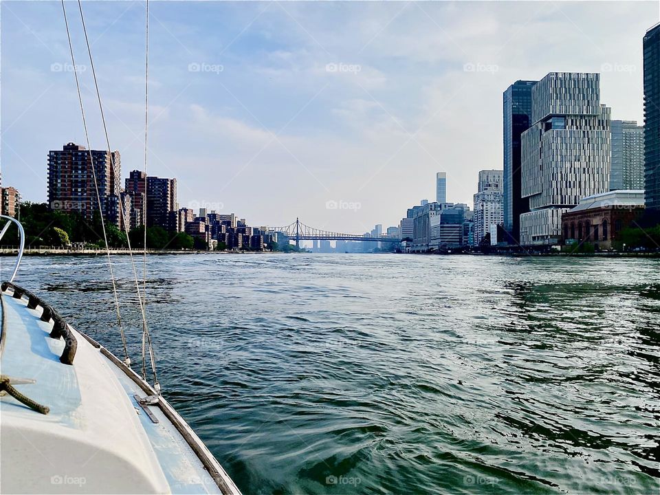 Traveling down the “East River” from “Mamaroneck” towards “Newtown Creek” in LIC, Queens we are taking in the sights on this beautiful sunny day. At the horizon we can now see the “59th St Ed Koch Queensboro Bridge”. 2023. Hypnotic Productions