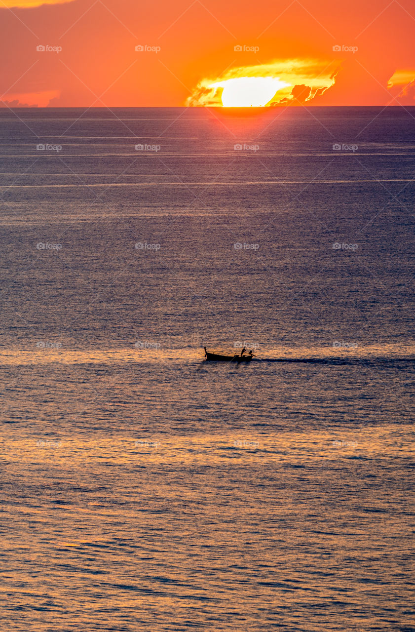 Fisherman come back home in the sunset moment