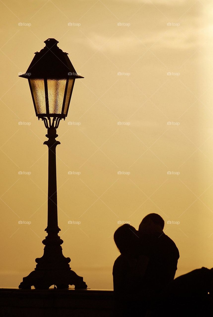 silhouette of a kissing couple at sunset