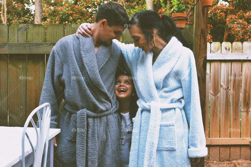 couple in robes with child