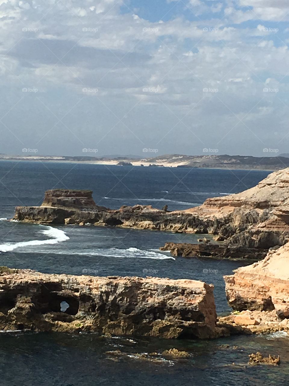 Sea ocean cliffs along south Australian coastline near coffin bay a national park, view out to sea, reefs in water, high surf, remote, wild, untouched 