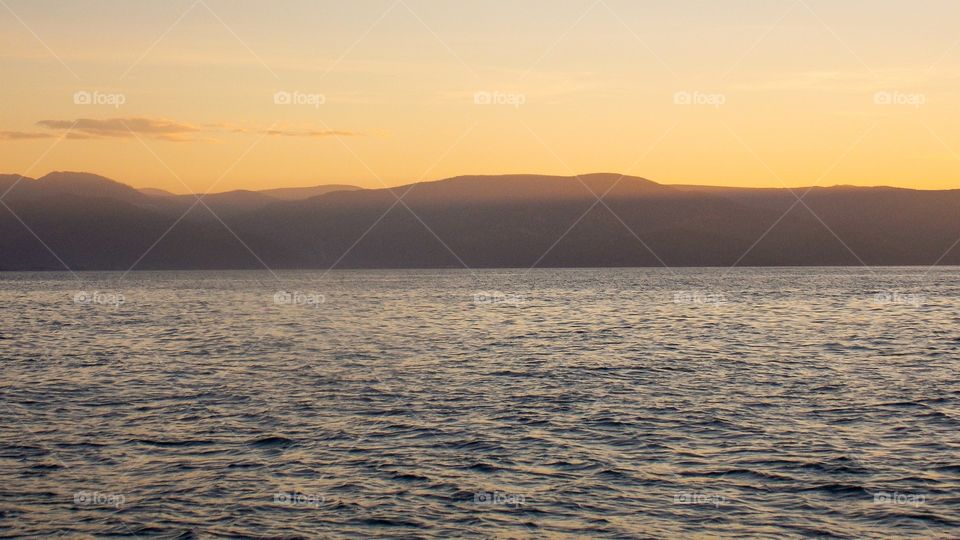 Khamar-Danan in the autumn sunset. The image taken from the surface of lake Baikal.
