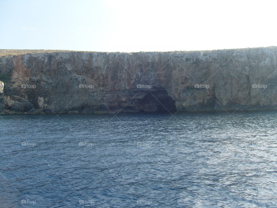Malta steep rocky seashore with Count Monte Cristo cave