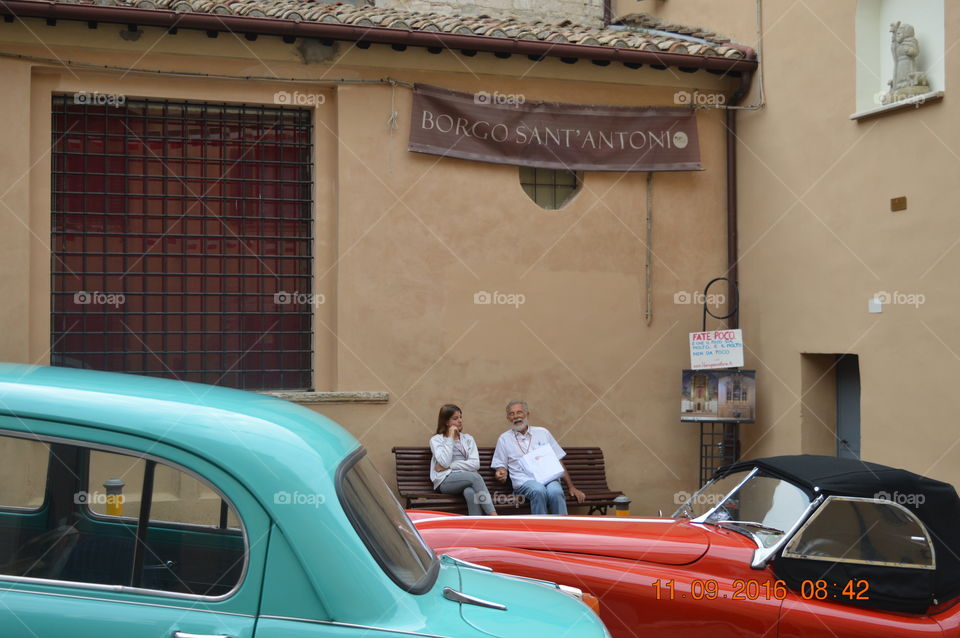 Senior man and woman sitting on bench