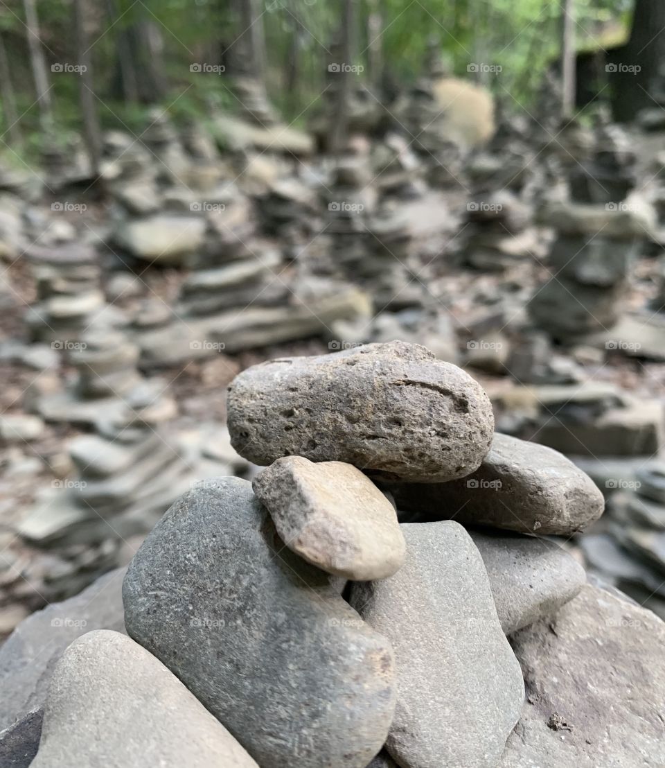 Many rocks piled on top of one another with some blurred out with a soft focus in the front. 