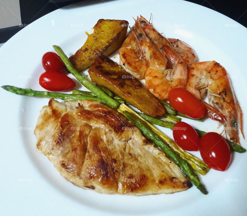 Grilled Chicken Breast and Prawns with pumpkin, asparagus, tomato.