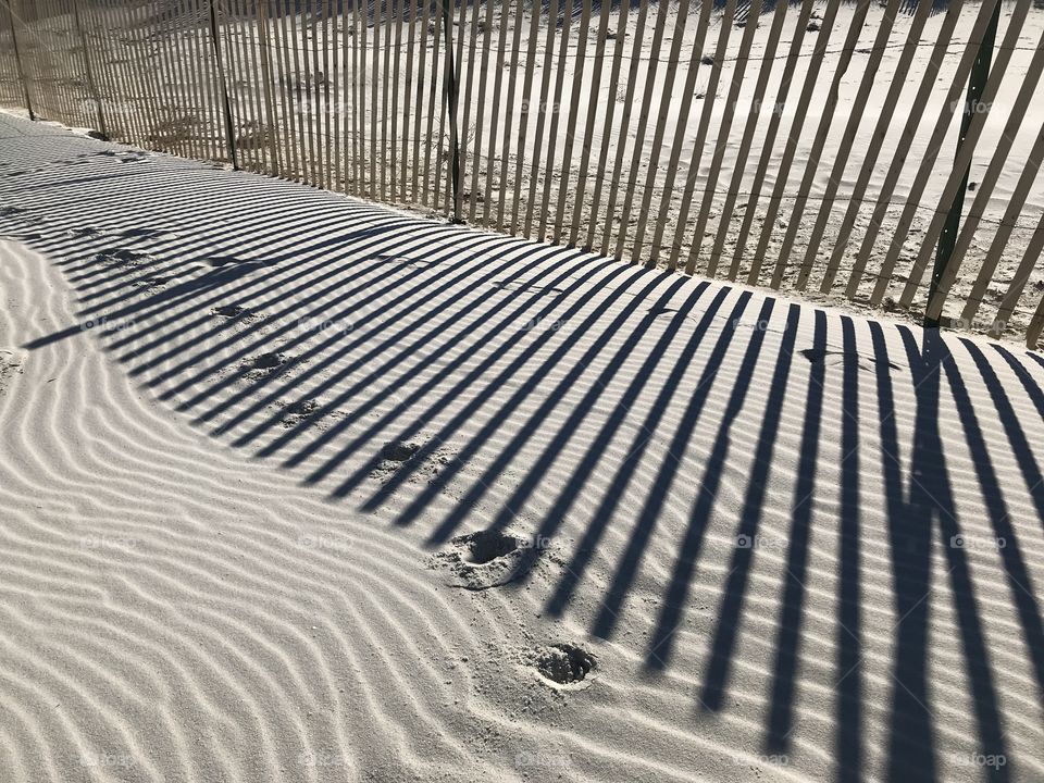 Footprints and shadows on the dune.